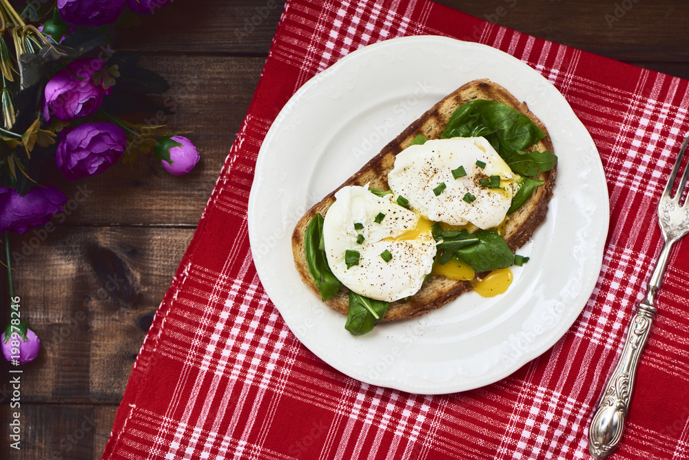 Tasty poached egg on toast over rustic background Tasty poached egg on toast over rustic background