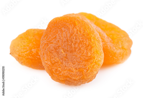 Dried apricot ingredient close up isolated on a white background. One orange apricot fruit with clipping path photo for advertising