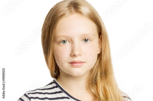 Cute teen girl with a serious face, close-up, isolated