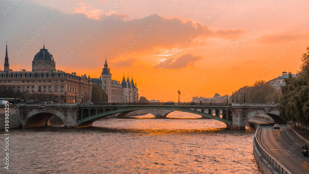 Sunset river sena paris, with boats and bridges in the background