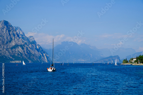 Yacht on mountain lake Lago di Gardo, Italy