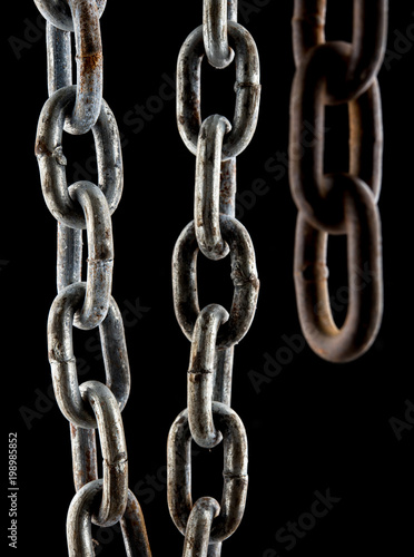 Close up old rusty chain isolated on black background.