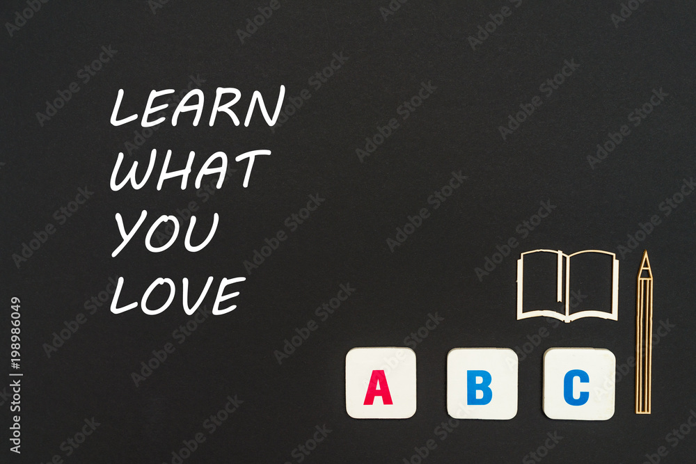 abc letters and chipboard miniature on blackboard with text learn what you love abc letters and chipboard miniature on blackboard with text learn what you love