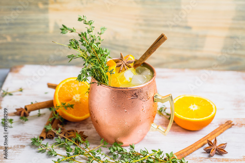 Photography Cold orange Moscow mule cocktail in copper mug. Selective focus.