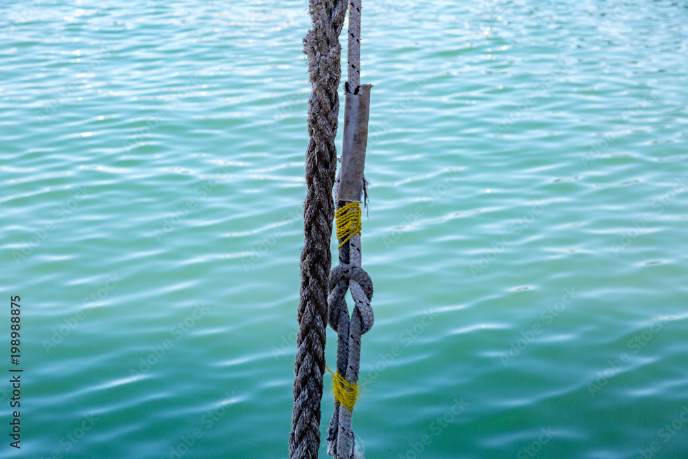 Thick mooring ship rope against the background of sea water
Thick mooring ship rope against the background of sea water