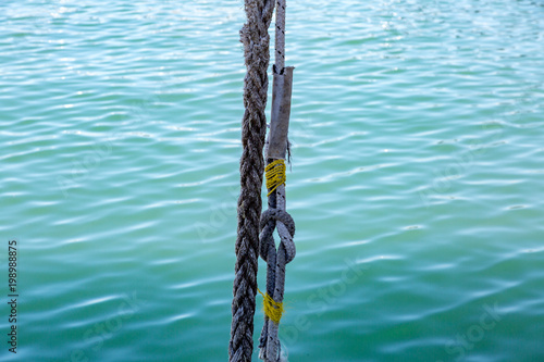 Thick mooring ship rope against the background of sea water   © ironstuffy