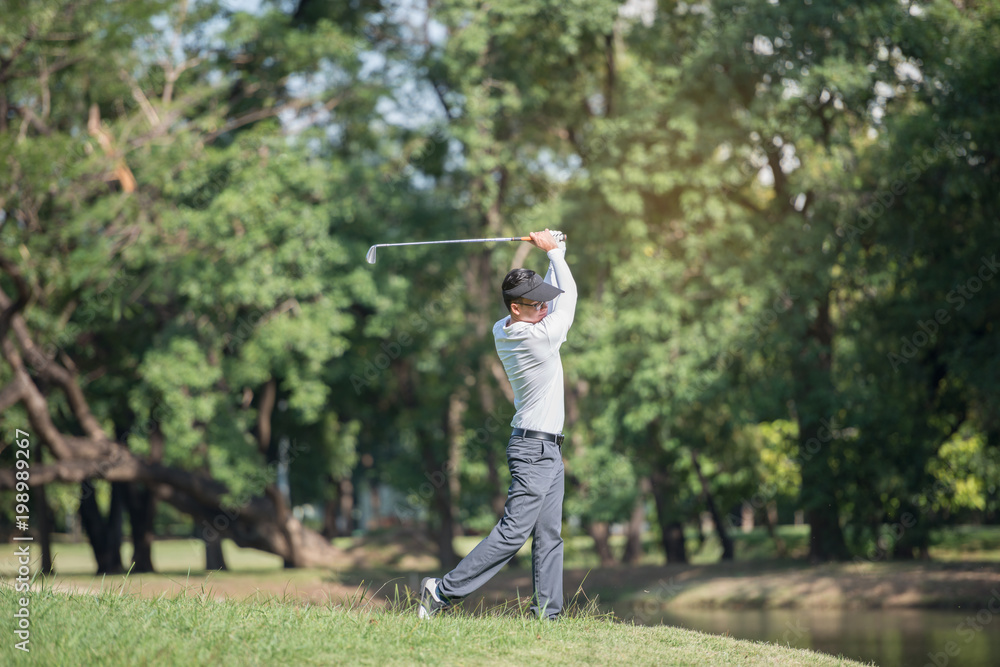 Golfers asia man show hit sweeping at green lawn.