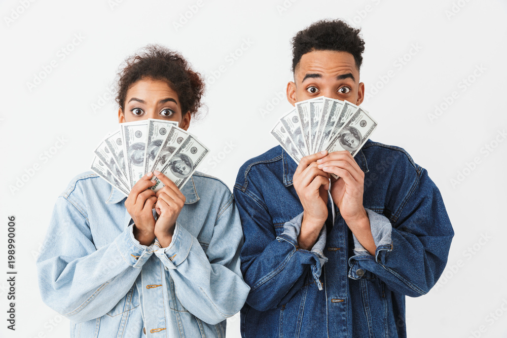 Surprised african couple in denim shirts covering their faces Surprised african couple in denim shirts covering their faces
