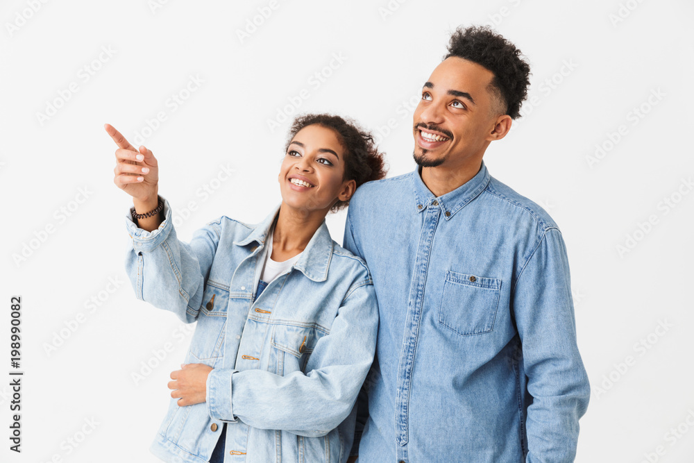 Happy african couple posing together and looking away Happy african couple posing together and looking away