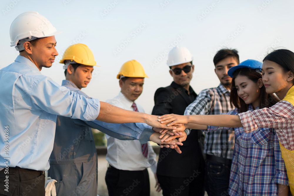 Stack hands of business engineer teamwork join together.Business partners shaking hand after complete a deal. Stack hands of business engineer teamwork join together.Business partners shaking hand after complete a deal.