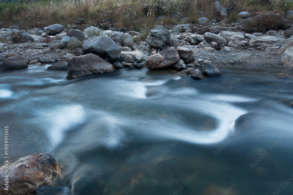 River water flowing through rocks at dawn River water flowing through rocks at dawn