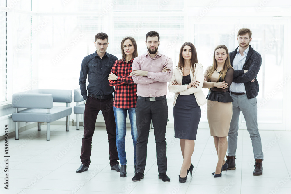 portrait of a professional business team standing in the middle of the spacious office