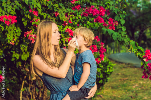 Vászonkép Mom looks at his son who is allergic to pollen