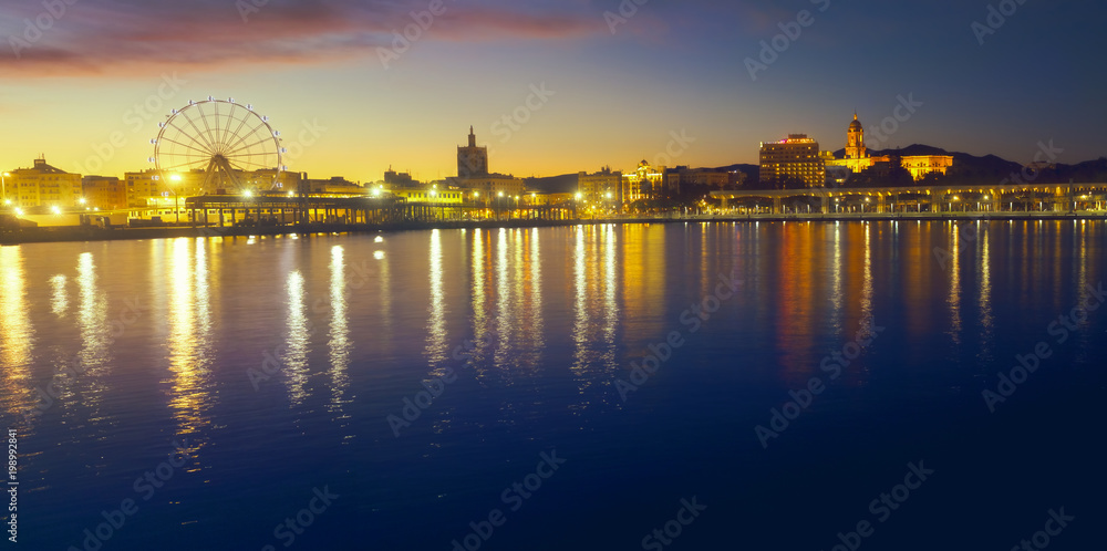 Panoramic view of Malaga city from harbour at sunset