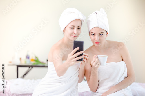 Beautiful young woman relaxing spa salon with taking selfi at spa resort