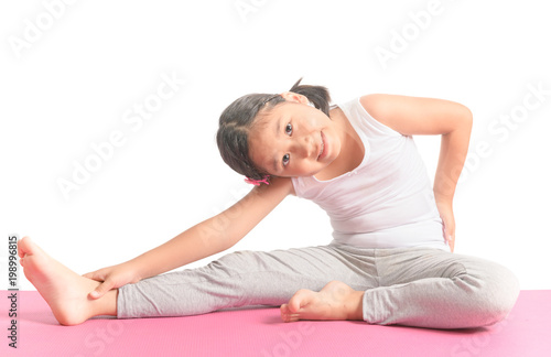 Haealthy asian kid exercise on yoga mat