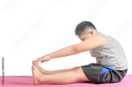 boy doing workout to lose weight on yoga mat isolated