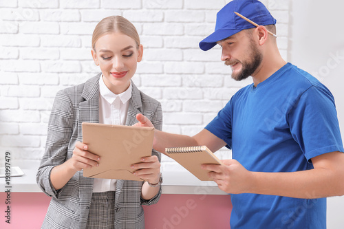 Female receptionist receivi...