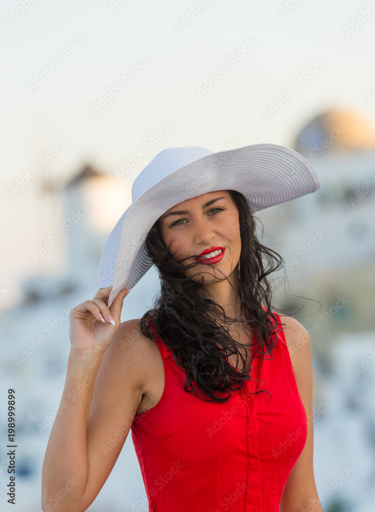 Φωτογραφία Santorini travel tourist brunette woman in red dress visiting famous white Oia village