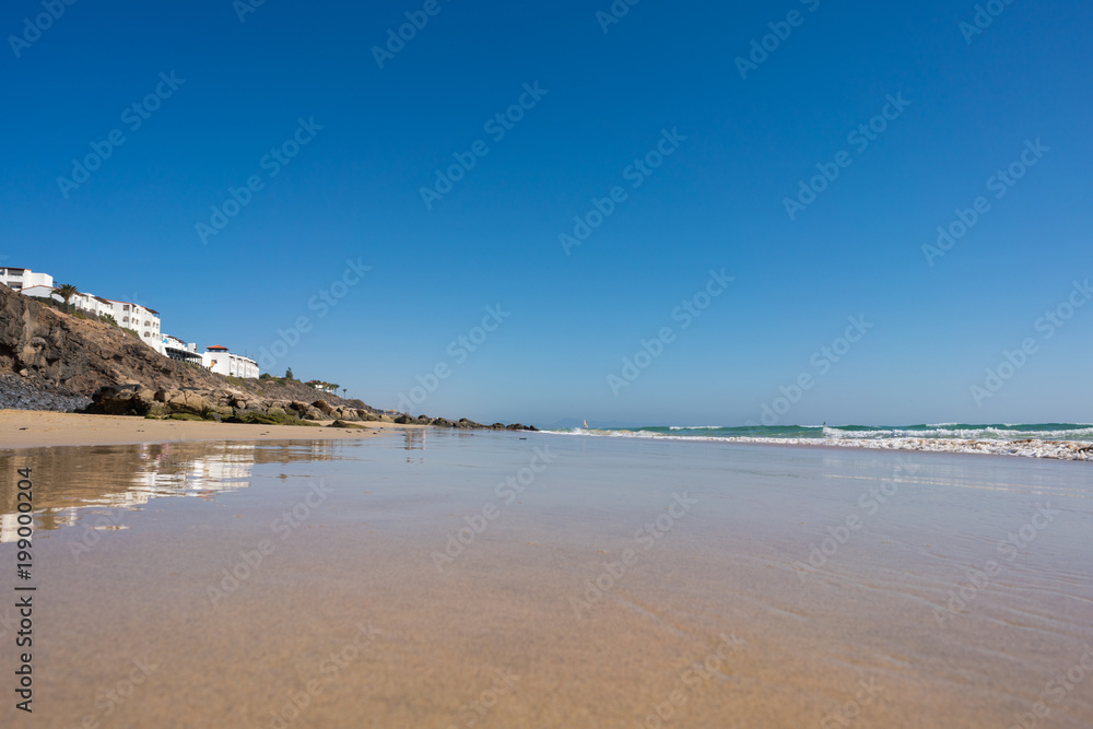 Calm sea and surf on a sandy beach. summer sea in Sunny weather with blue sky. Beautiful sandy beach and transparent waves Calm sea and surf on a sandy beach. summer sea in Sunny weather with blue sky. Beautiful sandy beach and transparent waves