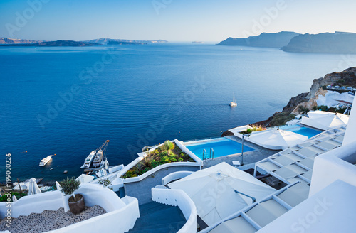 White architecture at Santorini island. Swimming pool in romantic luxury hotel at Oia town.