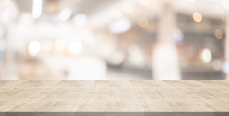 Wood table top on blurred background from shopping mall, Space for montage your products