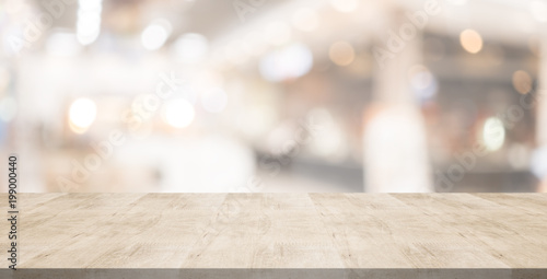 Wood table top on blurred background from shopping mall, Space for montage your products photo