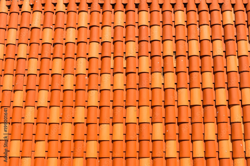Red orange clay roof tiles in seamless diagonal pattern on sunny day, abstract background texture, architectural details, Red orange clay roof tiles in seamless diagonal pattern on sunny day, abstract background texture, architectural details,