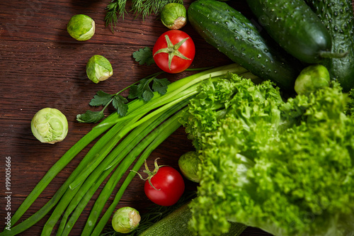 Fresh vegetables composition over wooden background, close-up, flat lay.