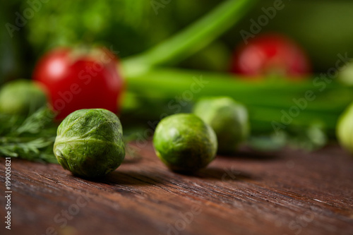 Fresh vegetables composition over wooden background, close-up, flat lay. © Aleksey