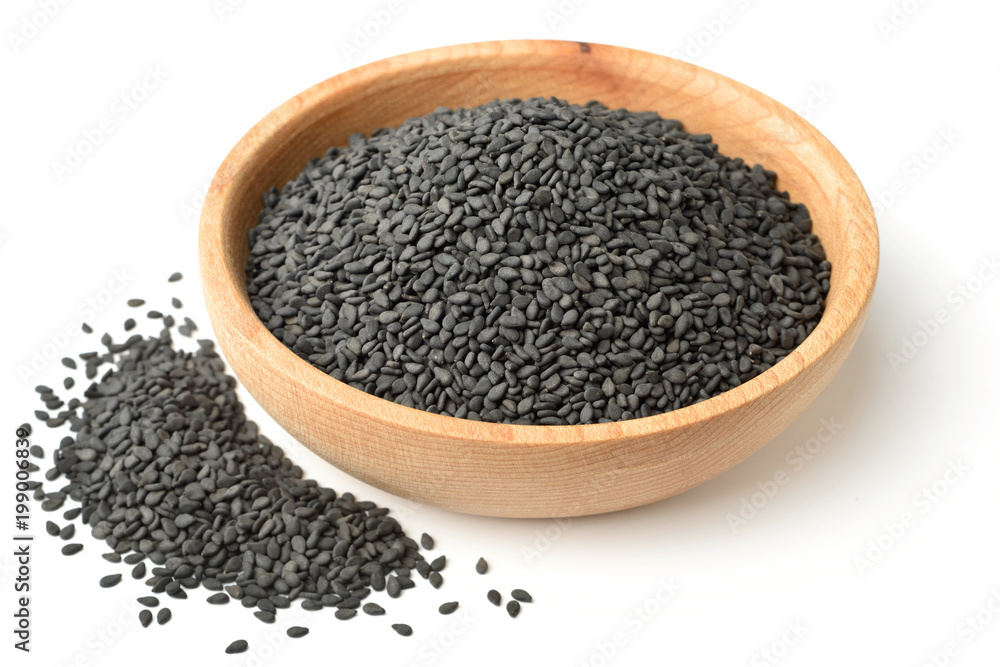 dried black sesame seeds in the wooden plate, isolated on white dried black sesame seeds in the wooden plate, isolated on white