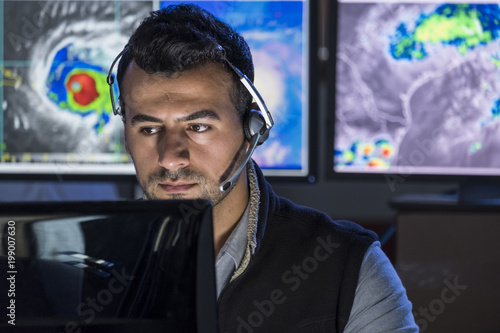 Obraz na plátně Meteorologist monitoring storms on his computer screen, close up shot
