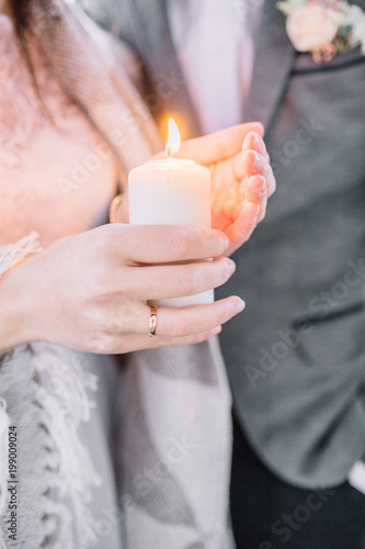 Young woman with candle in hands. Wedding festive concept.