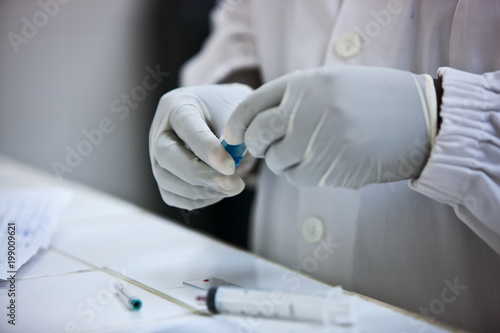 Hands of doctor holding blood test plates.