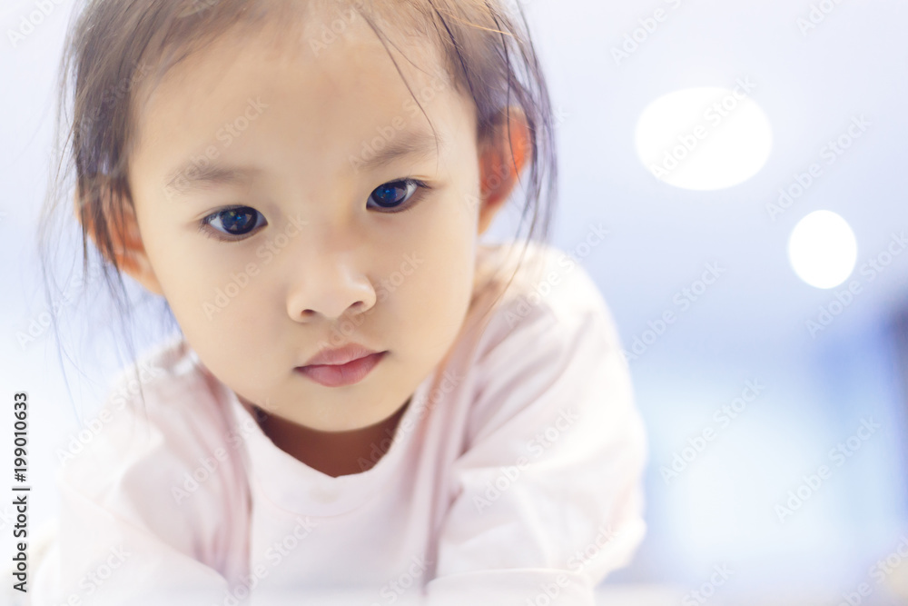 Child's watching a learning a lesson on the bed before bedtime. Child's watching a learning a lesson on the bed before bedtime.