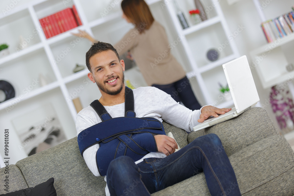 man with injured leg relaxing on the sofa man with injured leg relaxing on the sofa