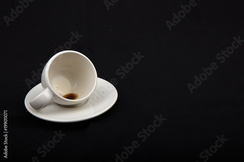 Empty little cup of coffee on the side