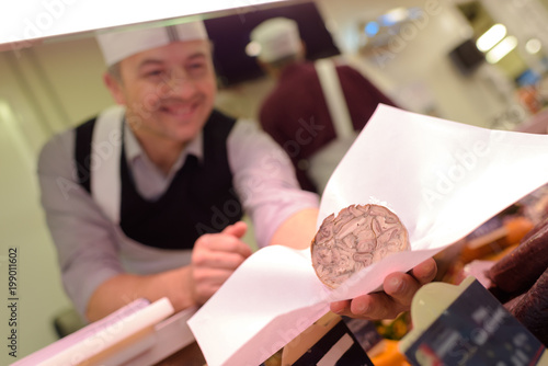 delicatessen worker handling down the customers order photo