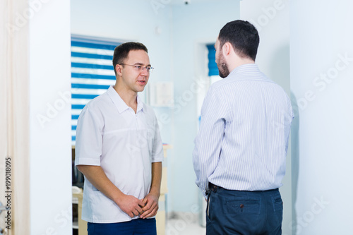 Doctor talking to a patient in a hallway