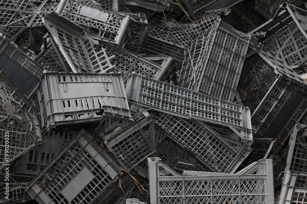 Fototapeta premium Piled black crates for scrap