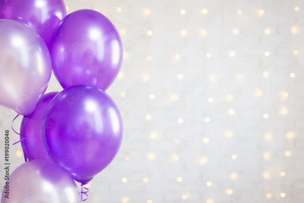 birthday party concept - air balloons over white brick wall background with lights birthday party concept - air balloons over white brick wall background with lights