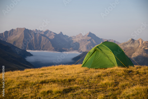 campaign through mountains with a tent 