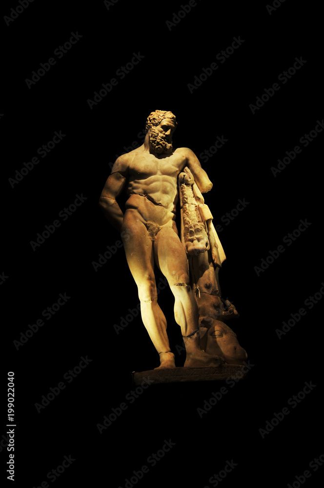 
A statue of powerful Hercules, closeup, isolated in black