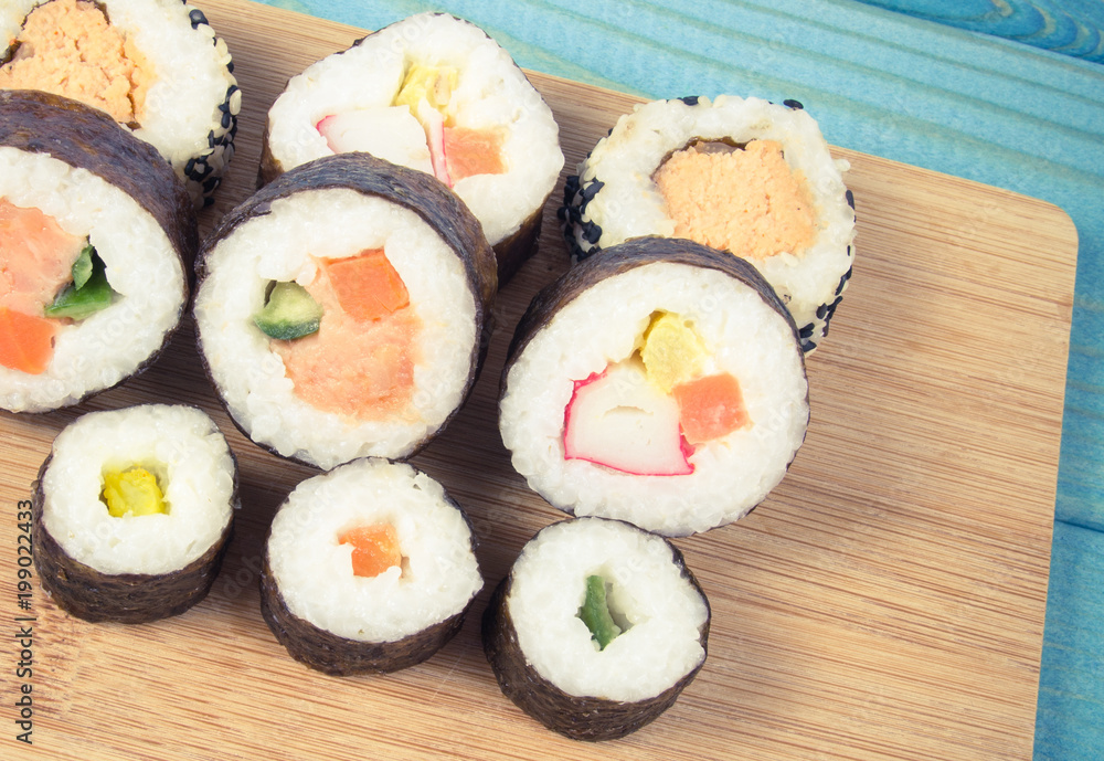 Various kinds of sushi on the blue background. Various kinds of sushi on the blue background.