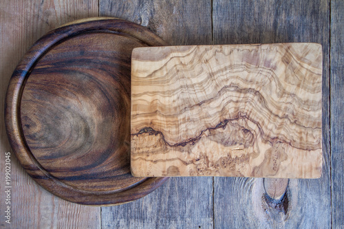 Chopping boards of different shapes on a wooden background. View from above.