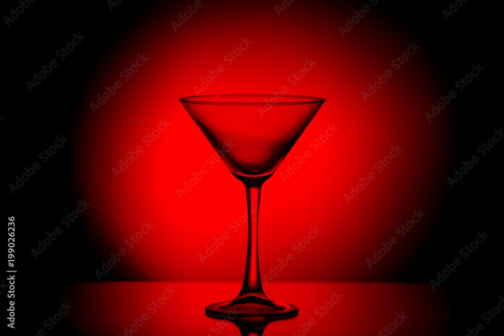 Martini glass in a gloomy blood red light.