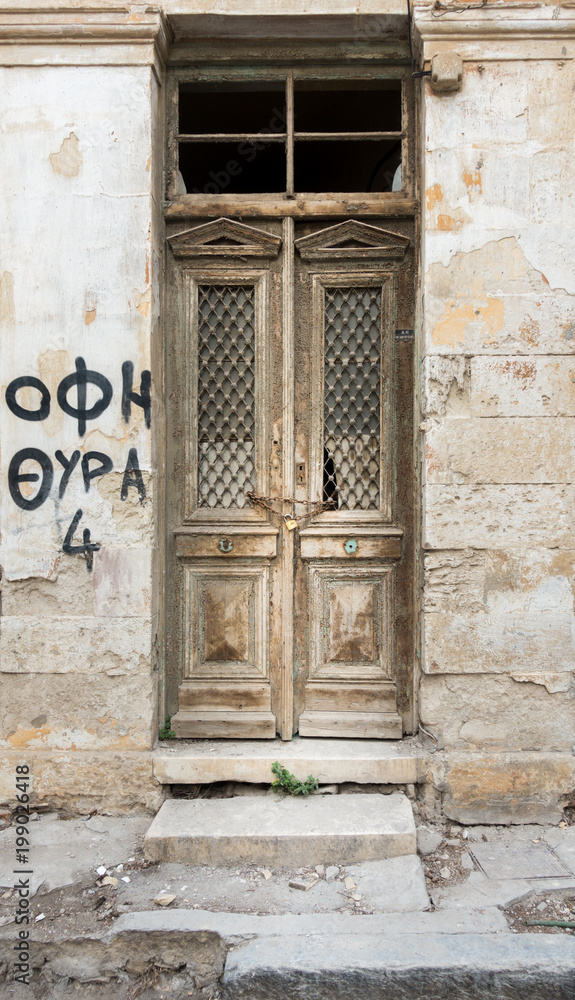 Old wooden door and weathered wall