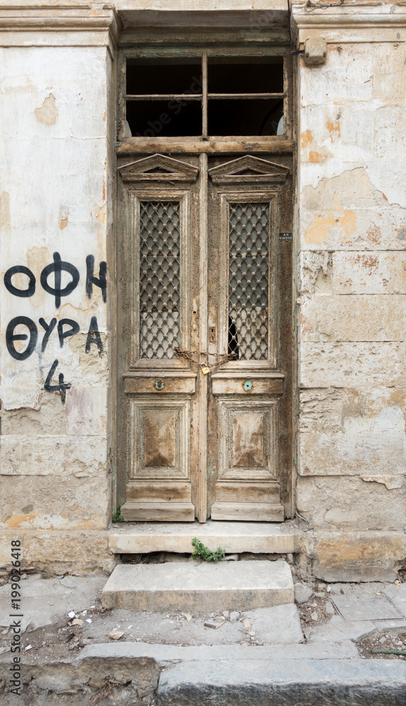 Fototapeta premium Old wooden door and weathered wall