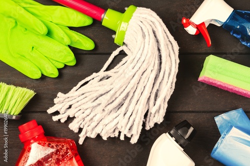 Cleaning supplies on wooden background