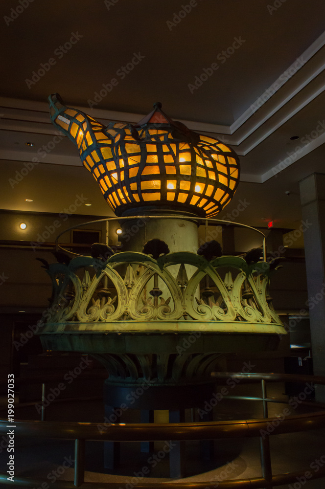 what represents the torch of the statue of liberty